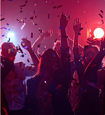 A group of people in a room with lights on.