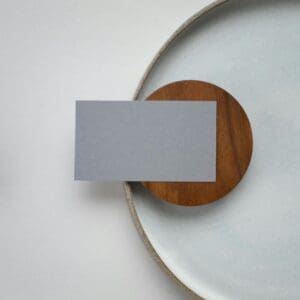 A white plate with a card on top of it.