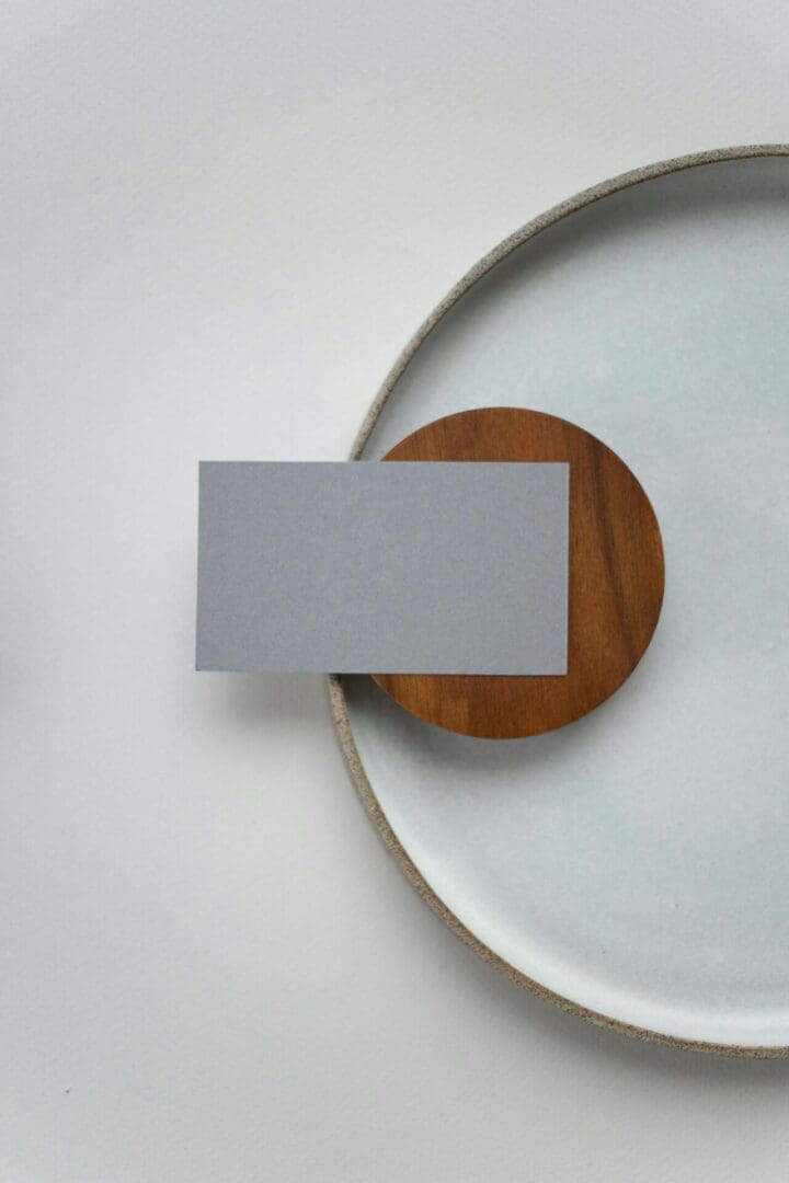 A white plate with a card on top of it.