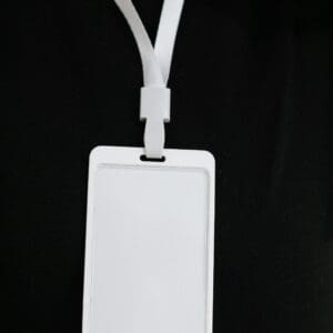 A white plastic tag with two cords attached to it.