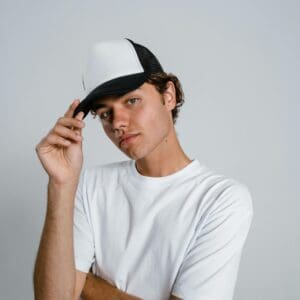 A man in white shirt and black hat