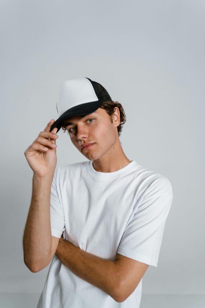 A man in white shirt and black hat