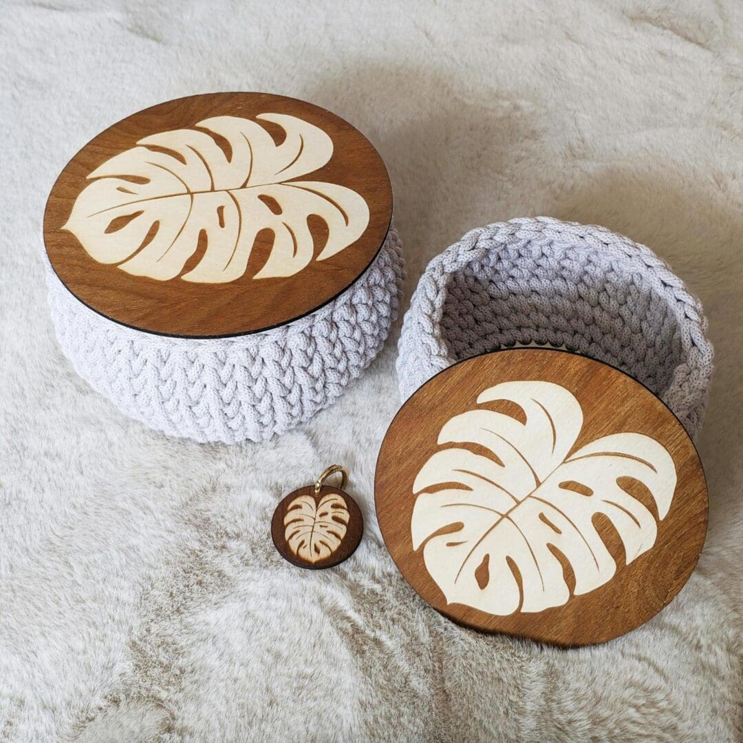 A wooden bowl and a crocheted basket with an apple core on top.