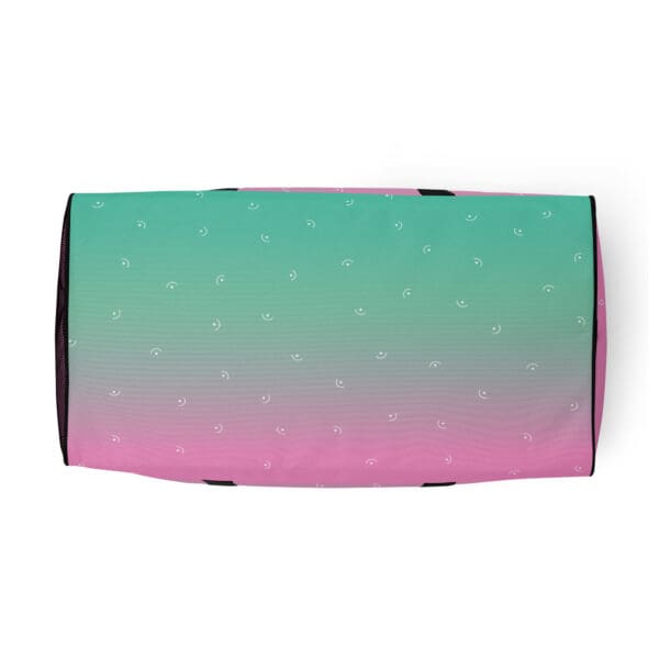 Pink and green ombre duffel bag with white smiles.