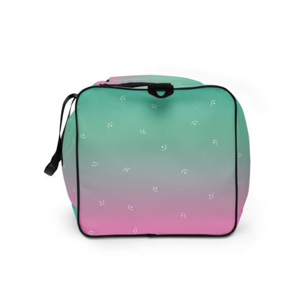 Green and pink duffel bag with smileys.