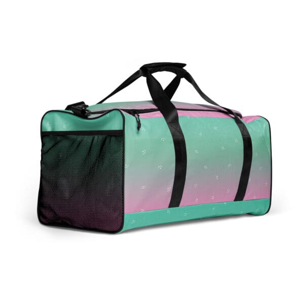 Green and pink travel duffel bag with smiley faces.