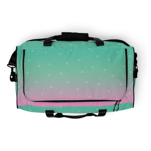 Green and pink duffel bag with smiles.